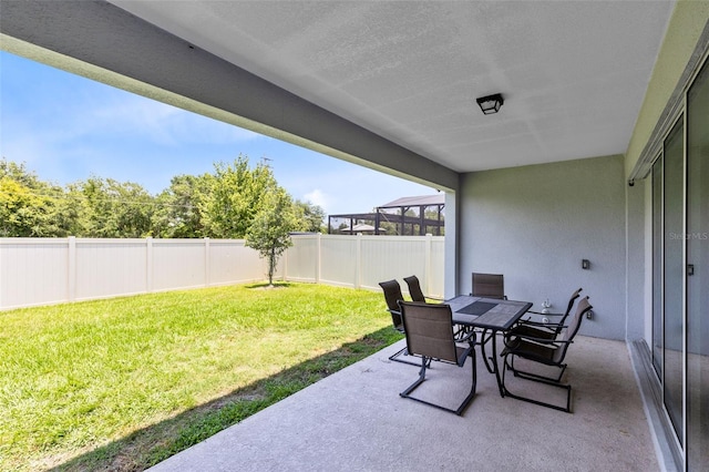 5677 Cedar Chase Dr, Saint Cloud, FL 34771 - fenced backyard featuring a patio and outdoor dining area