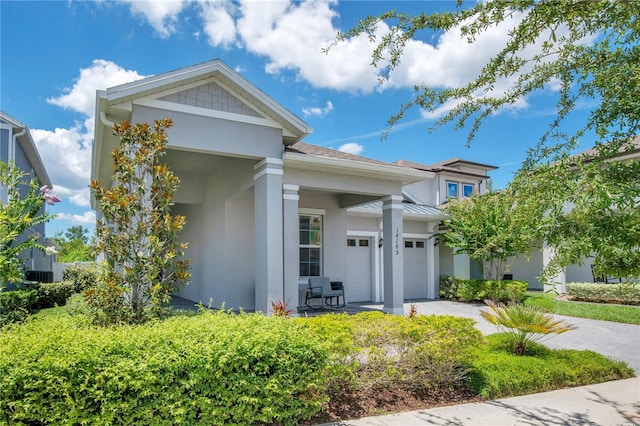 14189 Larkspur Lake Dr, Winter Garden, FL 34787 - view of front of property with stucco siding, a standing seam roof, a garage, driveway, and a metal roof