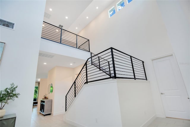 14189 Larkspur Lake Dr, Winter Garden, FL 34787 - stairs featuring a high ceiling, plenty of natural light, tile patterned floors, and recessed lighting
