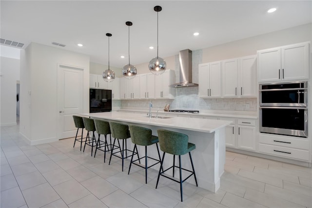 14189 Larkspur Lake Dr, Winter Garden, FL 34787 - kitchen featuring wall chimney exhaust hood, fridge, tasteful backsplash, stainless steel double oven, and recessed lighting