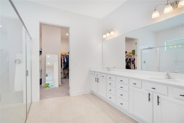 14189 Larkspur Lake Dr, Winter Garden, FL 34787 - bathroom with a walk in closet, double vanity, a shower stall, and tile patterned floors