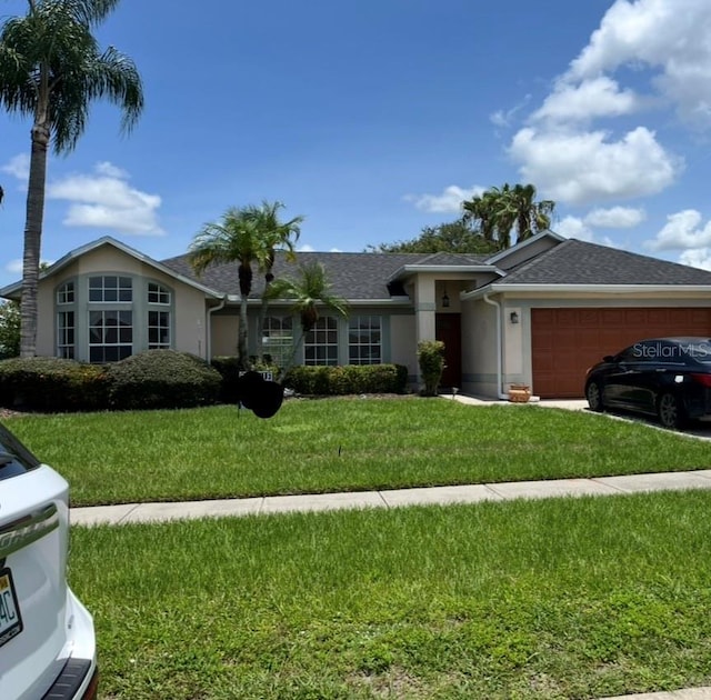 2421 Queenswood Cir, Kissimmee, FL 34743 - ranch-style house with a garage, stucco siding, a front yard, concrete driveway, and a shingled roof