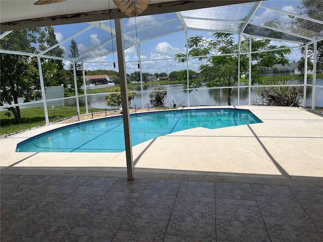 2421 Queenswood Cir, Kissimmee, FL 34743 - swimming pool featuring glass enclosure, a water view, and a patio area