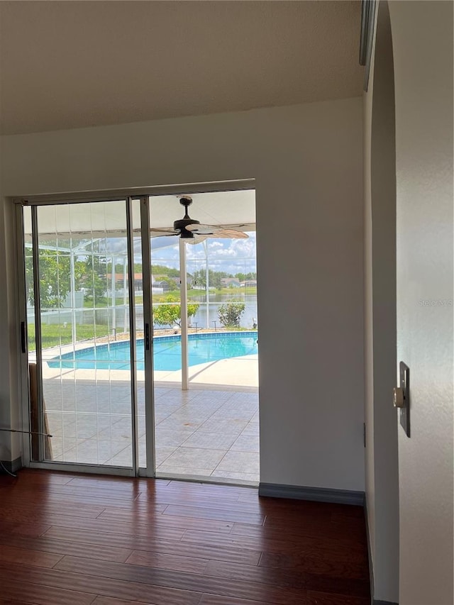 2421 Queenswood Cir, Kissimmee, FL 34743 - empty room with healthy amount of natural light, wood finished floors, a ceiling fan, and a water view