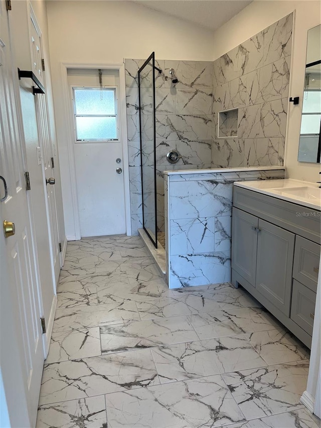2421 Queenswood Cir, Kissimmee, FL 34743 - full bath with a marble finish shower, vanity, marble finish floors, and tile walls