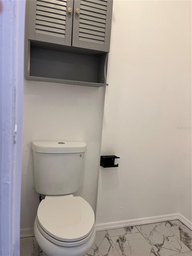 2421 Queenswood Cir, Kissimmee, FL 34743 - bathroom with baseboards and marble look tiles