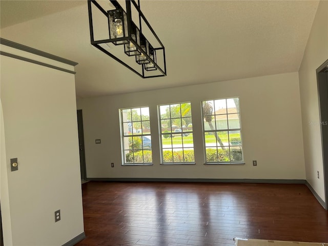 2421 Queenswood Cir, Kissimmee, FL 34743 - unfurnished room featuring lofted ceiling and dark wood-style flooring