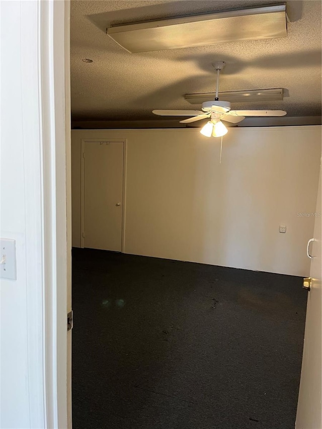 2421 Queenswood Cir, Kissimmee, FL 34743 - empty room with a ceiling fan and dark colored carpet