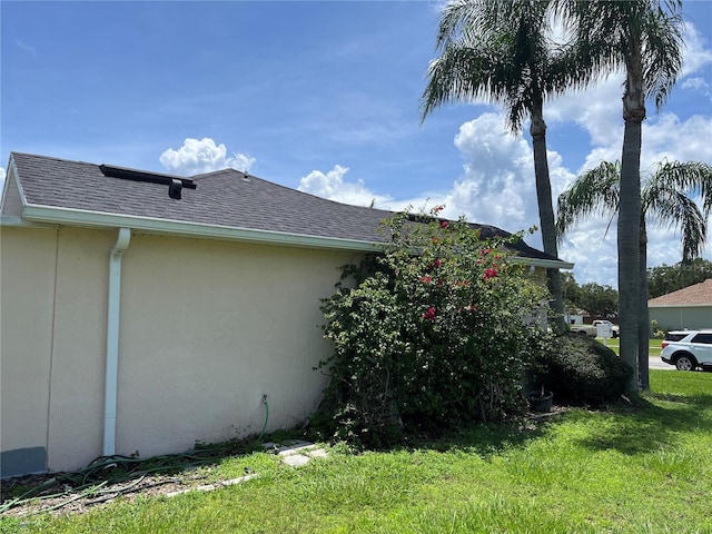 2421 Queenswood Cir, Kissimmee, FL 34743 - view of home's exterior with a lawn, stucco siding, and a shingled roof