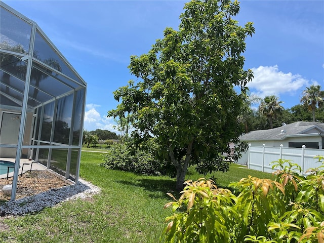 2421 Queenswood Cir, Kissimmee, FL 34743 - view of yard with glass enclosure and an outdoor pool