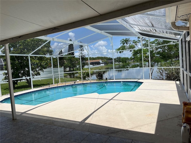 2421 Queenswood Cir, Kissimmee, FL 34743 - outdoor pool featuring glass enclosure, a patio, and a water view