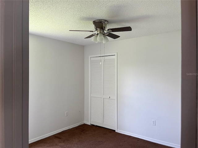 2421 Queenswood Cir, Kissimmee, FL 34743 - unfurnished bedroom with dark carpet, a closet, a textured ceiling, and a ceiling fan