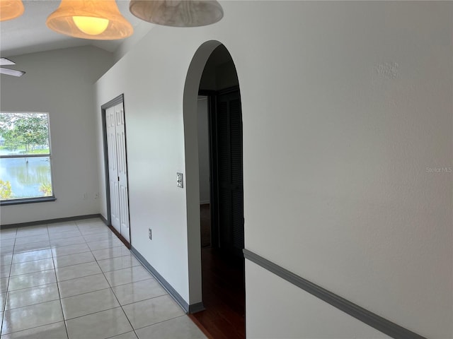 2421 Queenswood Cir, Kissimmee, FL 34743 - hall with arched walkways, vaulted ceiling, and light tile patterned flooring