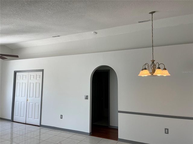 2421 Queenswood Cir, Kissimmee, FL 34743 - unfurnished room with arched walkways, a chandelier, a textured ceiling, ceiling fan, and light tile patterned flooring