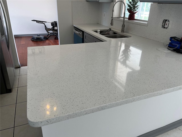 2421 Queenswood Cir, Kissimmee, FL 34743 - kitchen featuring dishwashing machine, light stone countertops, and a peninsula