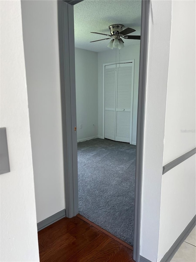 2421 Queenswood Cir, Kissimmee, FL 34743 - hallway with a textured ceiling and carpet