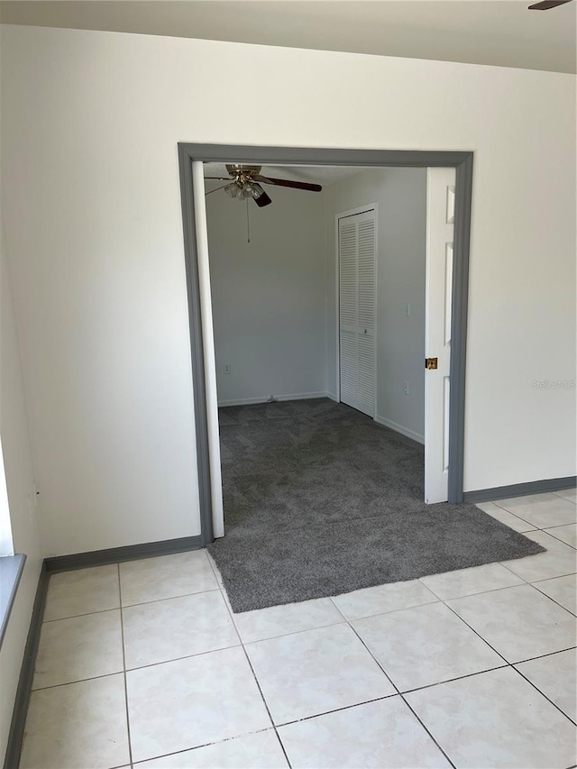 2421 Queenswood Cir, Kissimmee, FL 34743 - empty room with a ceiling fan, light colored carpet, and light tile patterned floors