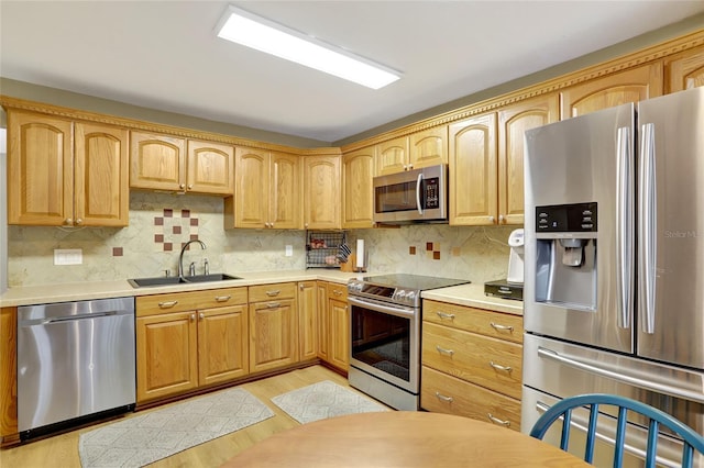 kitchen with stainless steel appliances, light wood-type flooring, light countertops, and tasteful backsplash