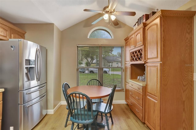 dining area featuring ceiling fan, light wood-type flooring, and lofted ceiling