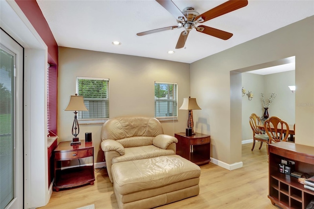 living area with light wood-type flooring, ceiling fan, and recessed lighting