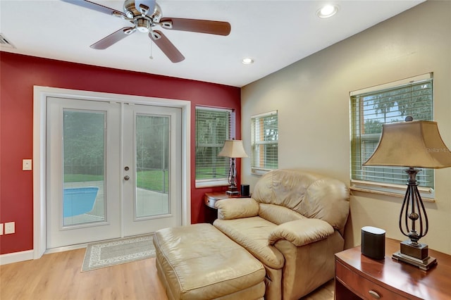 sitting room with french doors, light wood finished floors, ceiling fan, and recessed lighting
