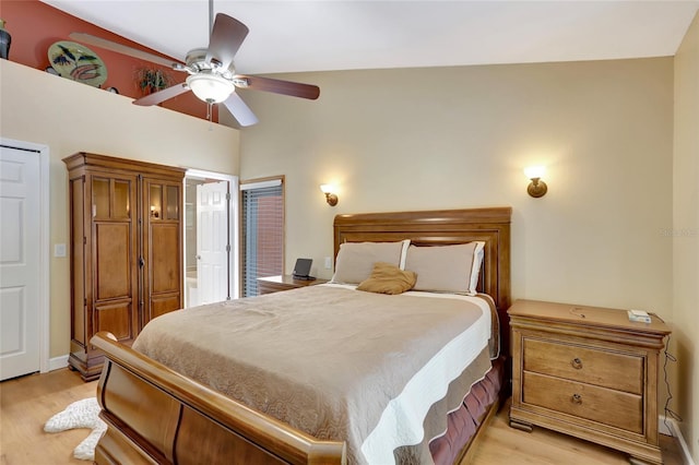 bedroom with light wood-style floors, a ceiling fan, and connected bathroom