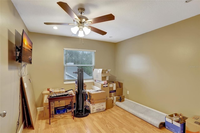 office space featuring wood finished floors and a ceiling fan
