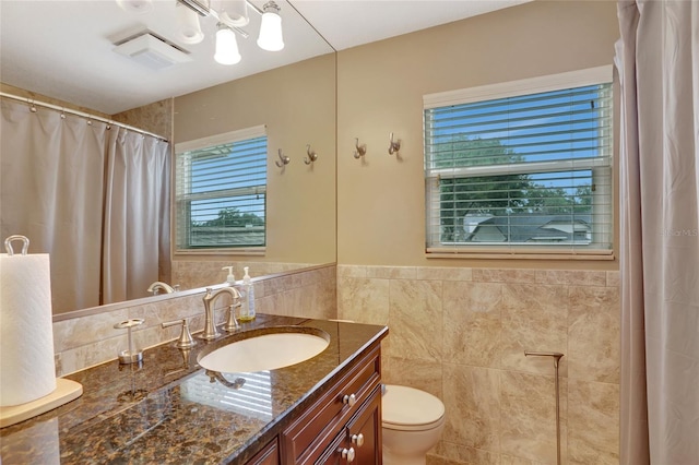 bathroom with vanity, tile walls, and a shower with curtain