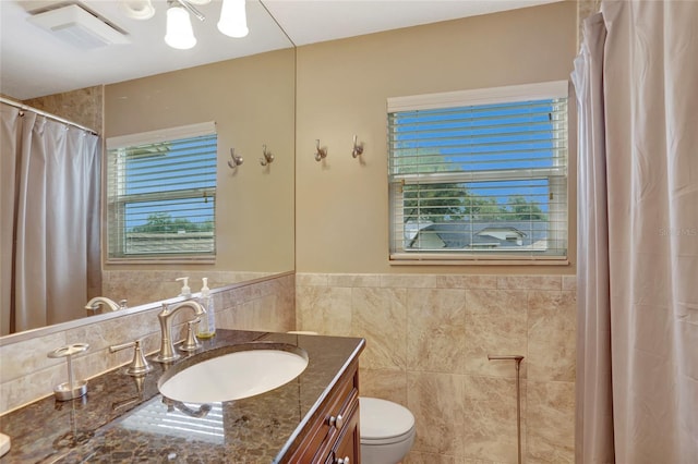 full bath featuring vanity, tile walls, and a shower with shower curtain