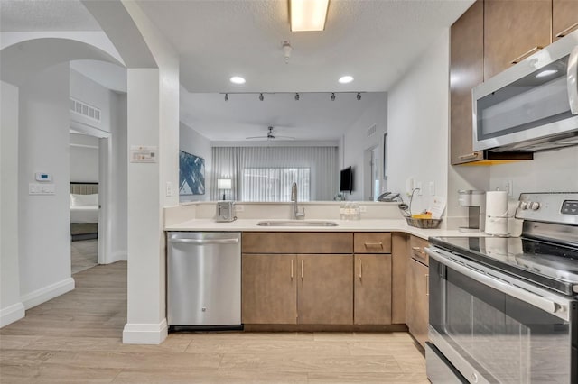14501 Grove Resort Ave Unit 3239, Winter Garden, FL 34787 - kitchen with appliances with stainless steel finishes, ceiling fan, light countertops, light wood-style flooring, and recessed lighting