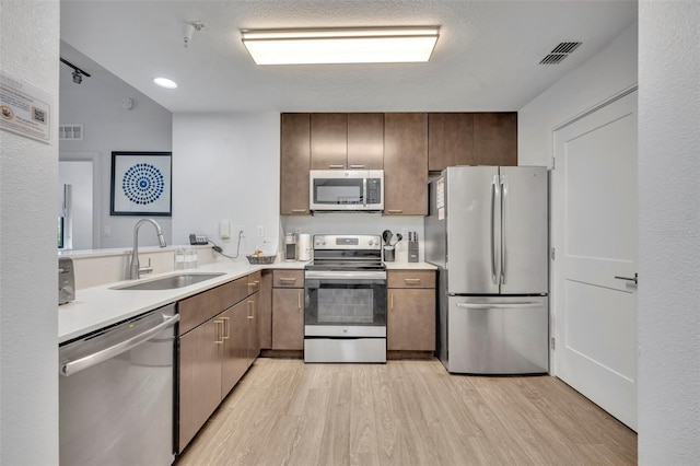 14501 Grove Resort Ave Unit 3239, Winter Garden, FL 34787 - kitchen featuring stainless steel appliances, light wood finished floors, light countertops, and recessed lighting