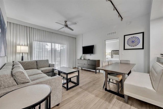 14501 Grove Resort Ave Unit 3239, Winter Garden, FL 34787 - living room featuring rail lighting, ceiling fan, and light wood-type flooring