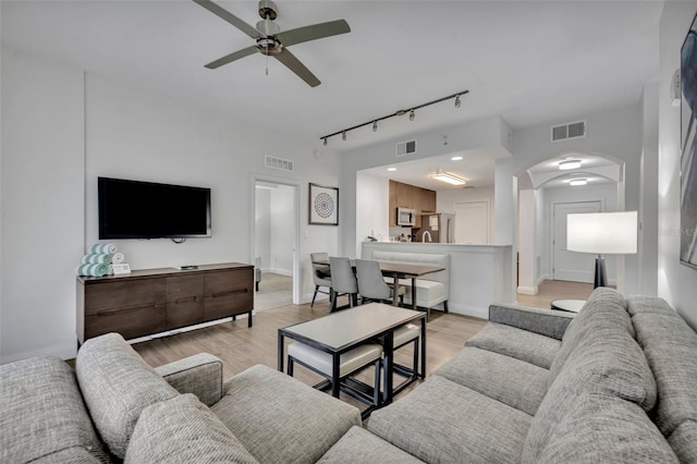 14501 Grove Resort Ave Unit 3239, Winter Garden, FL 34787 - living area featuring rail lighting, ceiling fan, arched walkways, and light wood-style floors