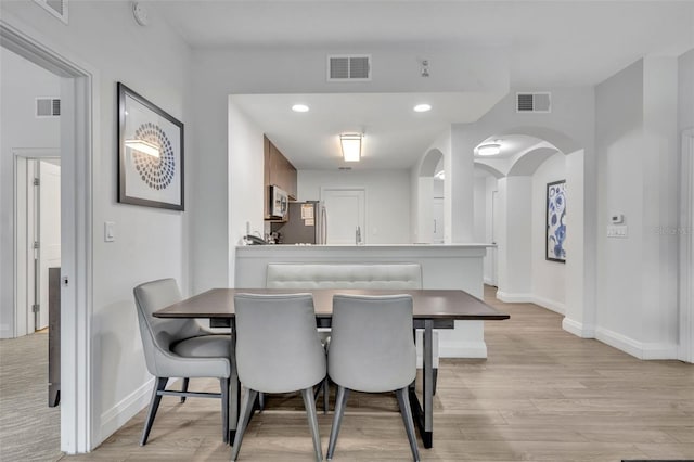 14501 Grove Resort Ave Unit 3239, Winter Garden, FL 34787 - dining room with arched walkways, light wood-type flooring, and recessed lighting