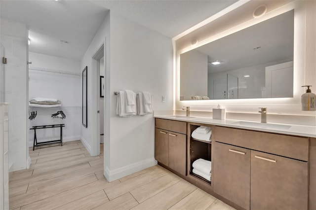 14501 Grove Resort Ave Unit 3239, Winter Garden, FL 34787 - bathroom with double vanity, wood finish floors, a spacious closet, and a shower with shower door