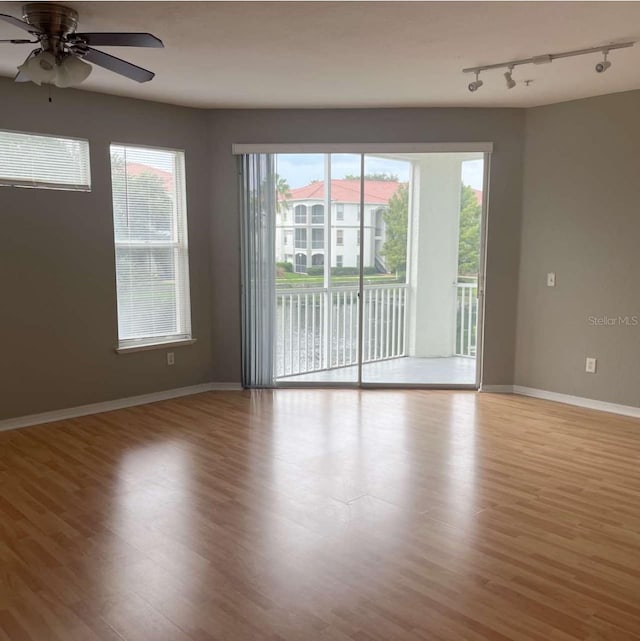 2525 Maitland Crossing Way Unit 202, Orlando, FL 32810 - unfurnished room featuring track lighting, wood finished floors, and a ceiling fan
