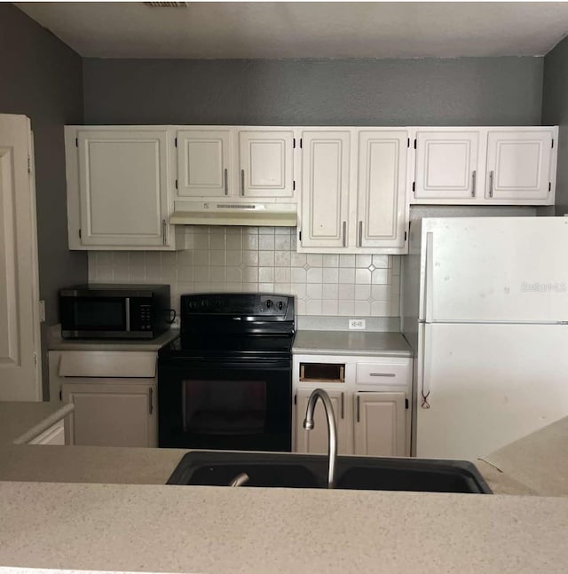 2525 Maitland Crossing Way Unit 202, Orlando, FL 32810 - kitchen featuring black electric range, stainless steel microwave, freestanding refrigerator, under cabinet range hood, and decorative backsplash
