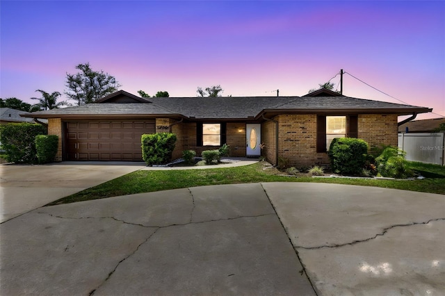 1736 Saxon Blvd, Deltona, FL 32725 - ranch-style home with brick siding, a garage, and concrete driveway