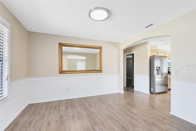 1736 Saxon Blvd, Deltona, FL 32725 - empty room featuring light wood-type flooring and arched walkways