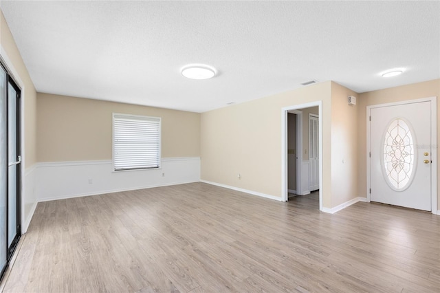 1736 Saxon Blvd, Deltona, FL 32725 - foyer with plenty of natural light, a textured ceiling, and light wood finished floors