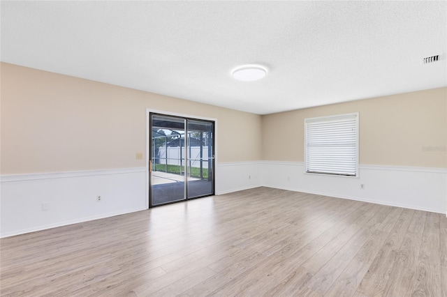 1736 Saxon Blvd, Deltona, FL 32725 - unfurnished room featuring light wood-style flooring and a textured ceiling
