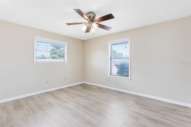 1736 Saxon Blvd, Deltona, FL 32725 - unfurnished room featuring healthy amount of natural light, light wood-type flooring, and a ceiling fan