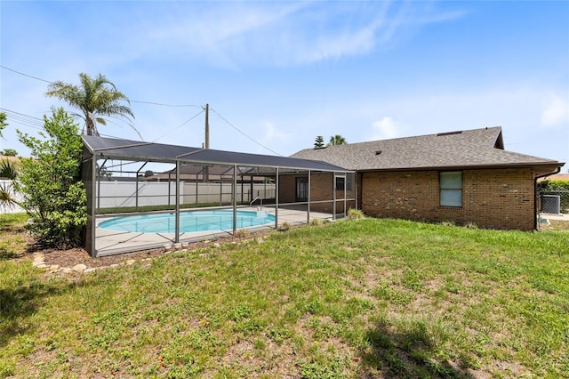 1736 Saxon Blvd, Deltona, FL 32725 - back of house with a lanai, brick siding, and a shingled roof