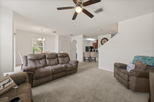 3537 Seneca Club Loop Unit B, Orlando, FL 32808 - living room featuring a chandelier, light colored carpet, a ceiling fan, and baseboards