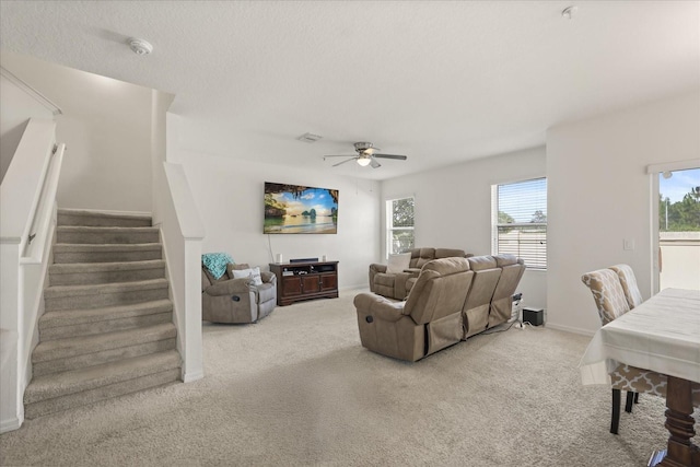 3537 Seneca Club Loop Unit B, Orlando, FL 32808 - living area with carpet floors, stairs, a ceiling fan, and baseboards