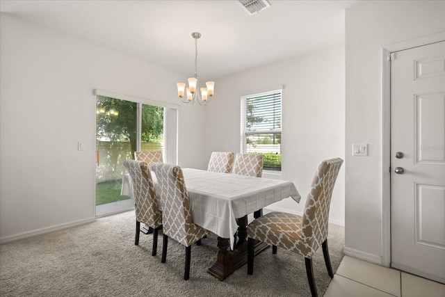 3537 Seneca Club Loop Unit B, Orlando, FL 32808 - dining area featuring a chandelier, baseboards, and light colored carpet
