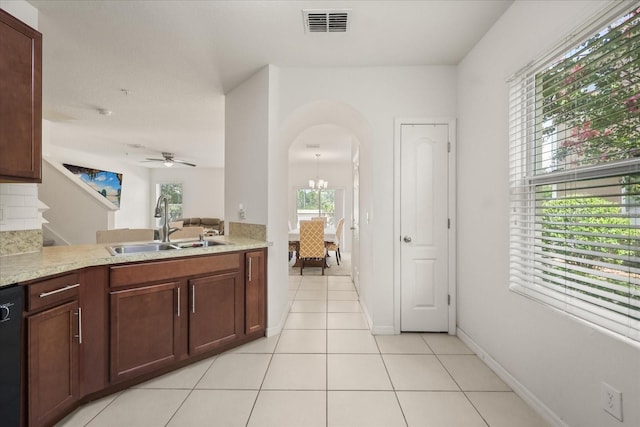 3537 Seneca Club Loop Unit B, Orlando, FL 32808 - kitchen with arched walkways, healthy amount of natural light, a sink, and light countertops