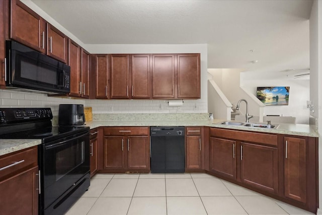 3537 Seneca Club Loop Unit B, Orlando, FL 32808 - kitchen featuring black appliances, a sink, decorative backsplash, light tile patterned flooring, and a peninsula