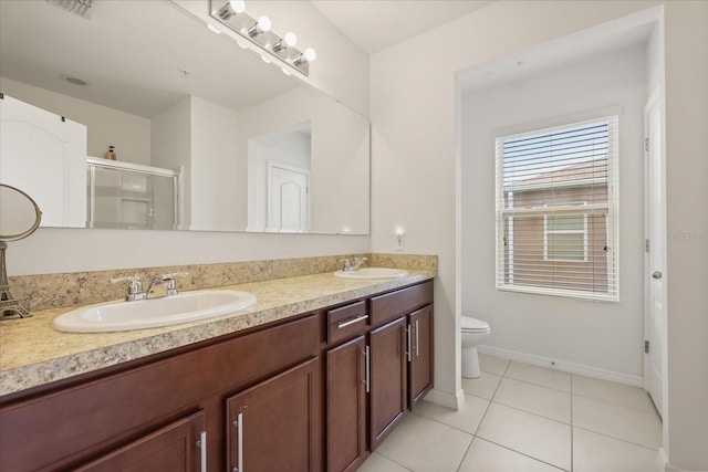 3537 Seneca Club Loop Unit B, Orlando, FL 32808 - full bathroom with toilet, double vanity, a stall shower, tile patterned floors, and baseboards