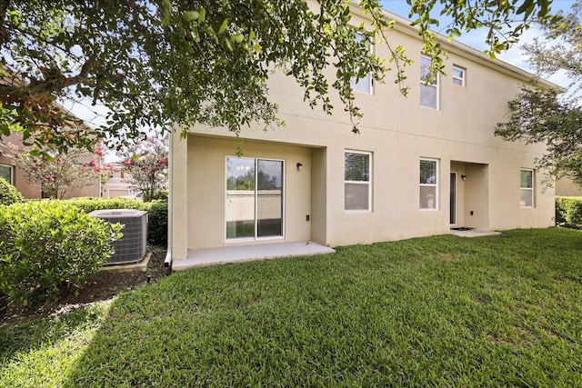 3537 Seneca Club Loop Unit B, Orlando, FL 32808 - back of property with central AC unit, a yard, and stucco siding